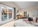 Spacious main bedroom with balcony access, a cozy seating area, and ample natural light at 30 Garfield St # B, Denver, CO 80206