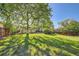 Large backyard featuring a well-maintained lawn, trees, and patio area for outdoor enjoyment at 7294 S Syracuse St, Centennial, CO 80112
