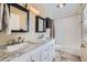 Bathroom features a double vanity with marble countertop, a shower-tub combo and neutral finishes at 7294 S Syracuse St, Centennial, CO 80112
