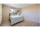 Bedroom featuring a comfortable bed, natural light from the window, and neutral-toned walls at 7294 S Syracuse St, Centennial, CO 80112