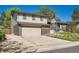 Two-story home with a brick and vinyl exterior and a spacious two-car garage and driveway at 7294 S Syracuse St, Centennial, CO 80112