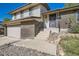 Charming home featuring a well-maintained front entrance with stone accents and landscaped details at 7294 S Syracuse St, Centennial, CO 80112