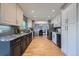 Spacious kitchen showcasing granite countertops, a view to the dining area, and stainless steel appliances at 7294 S Syracuse St, Centennial, CO 80112
