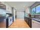 Bright kitchen featuring stainless steel appliances, granite countertops, and custom two-tone cabinetry at 7294 S Syracuse St, Centennial, CO 80112