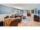 Bright living room featuring hardwood floors, large window, and comfortable seating arrangement at 7294 S Syracuse St, Centennial, CO 80112