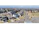 Aerial view showing the house and surrounding neighborhood with mountain views in the distance at 117 Nova Ct, Erie, CO 80516