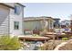 Backyard with a lounge area, hot tub, mature landscaping, and charming water feature at 117 Nova Ct, Erie, CO 80516