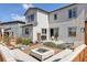 Modern backyard with a fire pit, patio seating, and beautiful landscaping in a fenced yard at 117 Nova Ct, Erie, CO 80516