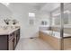 Bathroom features soaking tub, large format tile floor and granite countertops at 117 Nova Ct, Erie, CO 80516
