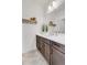 Clean bathroom with dark wood cabinets, white countertops, and modern fixtures at 117 Nova Ct, Erie, CO 80516