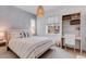 Bright bedroom with a queen-sized bed, decorative lighting, and a work area at 117 Nova Ct, Erie, CO 80516