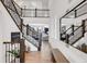 Grand foyer with hardwood floors, staircase with decorative railings, and a large decorative mirror at 117 Nova Ct, Erie, CO 80516