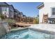 Custom hot tub with tiled accents and stone waterfall feature in a landscaped yard at 117 Nova Ct, Erie, CO 80516