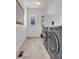 Convenient laundry room with front loading washer and dryer and storage shelves at 117 Nova Ct, Erie, CO 80516
