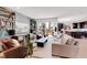 Spacious living room featuring modern furnishings, a sliding glass door, and an open layout to the kitchen at 117 Nova Ct, Erie, CO 80516