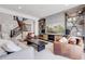 Bright living room with a cozy seating area, decorative shelving, and a stylish entertainment center at 117 Nova Ct, Erie, CO 80516