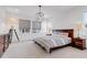 Bright and open main bedroom featuring neutral colors and a modern globe chandelier at 117 Nova Ct, Erie, CO 80516