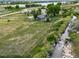 Aerial view of home on large lot with river running behind the property at 14831 Riverdale Rd, Brighton, CO 80602