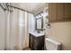 Cozy bathroom featuring a modern vanity with storage and shower at 14831 Riverdale Rd, Brighton, CO 80602