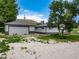Exterior shot of a two-car detached garage with a two-tone house at 14831 Riverdale Rd, Brighton, CO 80602