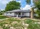 Exterior shot of a newly painted two-tone home with a brick chimney at 14831 Riverdale Rd, Brighton, CO 80602