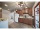 Kitchen features wood cabinets, stainless sink, and modern overhead lighting at 14831 Riverdale Rd, Brighton, CO 80602