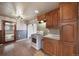 Traditional kitchen featuring wood cabinets, white appliances, and wood-look floors at 14831 Riverdale Rd, Brighton, CO 80602