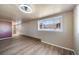 Spacious living room featuring wood floors, large window, and neutral paint at 14831 Riverdale Rd, Brighton, CO 80602