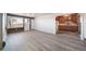 Open-concept living room showing the kitchen and ample natural light at 14831 Riverdale Rd, Brighton, CO 80602