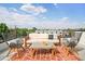 Relaxing rooftop deck with seating and city views at 4490 W 45Th Ave, Denver, CO 80212