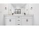 Bathroom featuring a double vanity with sleek black fixtures and a large mirror at 16671 W 93Rd Ave, Arvada, CO 80007