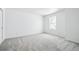Carpeted bedroom with neutral walls and a well-lit window at 16671 W 93Rd Ave, Arvada, CO 80007