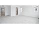 Well-lit bedroom featuring neutral walls, carpeting, and ample doorway space at 16671 W 93Rd Ave, Arvada, CO 80007