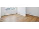 Bright bedroom with light wood floors, white walls, two windows, and ample space for customization at 16671 W 93Rd Ave, Arvada, CO 80007