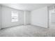 Light-filled bedroom with a view and soft carpeting at 16671 W 93Rd Ave, Arvada, CO 80007