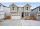 Charming two-story home featuring stone accents, gray siding, a two-car garage, and a well-manicured front yard at 16671 W 93Rd Ave, Arvada, CO 80007