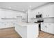 Modern kitchen featuring white cabinetry, stainless steel appliances, a large island, and ample counter space at 16671 W 93Rd Ave, Arvada, CO 80007