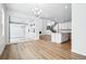 Bright living area with hardwood floors that flows into a modern kitchen and dining area with access to an outdoor space at 16671 W 93Rd Ave, Arvada, CO 80007