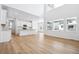 Expansive open-concept living space featuring high ceilings, hardwood floors, and a modern kitchen with a large island at 16671 W 93Rd Ave, Arvada, CO 80007