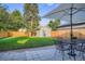 Lush backyard featuring a well-maintained lawn, a patio dining set, and a storage shed for outdoor enjoyment at 1818 S Humboldt St, Denver, CO 80210