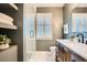 Stylish bathroom featuring a glass-enclosed shower, modern fixtures, and a wooden vanity at 1818 S Humboldt St, Denver, CO 80210