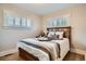 Inviting bedroom with natural wood bed frame, neutral tones, soft textures, and shuttered windows for a tranquil retreat at 1818 S Humboldt St, Denver, CO 80210