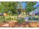 Charming home exterior featuring well-manicured landscaping and mature trees enhancing curb appeal at 1818 S Humboldt St, Denver, CO 80210