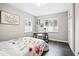 Inviting bedroom featuring a functional desk area and a cozy floral comforter that enhances the room's charm at 1100 Gaylord St, Denver, CO 80206