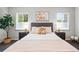 Bright bedroom featuring a comfortable bed with decorative pillows, complemented by matching bedside tables and lamps at 1100 Gaylord St, Denver, CO 80206