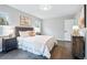 Serene bedroom with hardwood floors, a cozy bed, and natural light creates a peaceful retreat for restful nights at 1100 Gaylord St, Denver, CO 80206
