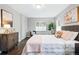 Charming bedroom with a plush quilted bed, stylish dresser, and a serene ambiance with a large window view at 1100 Gaylord St, Denver, CO 80206
