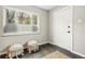 Inviting entryway with hardwood floors, a large window, and stylish decorative poufs for a welcoming first impression at 1100 Gaylord St, Denver, CO 80206
