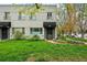 Charming two-story building with brick facade, tidy lawn, and landscaped garden beds flanking the entrances at 1100 Gaylord St, Denver, CO 80206