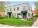 Charming two-story building with brick facade, tidy lawn, and landscaped garden beds flanking the entrances at 1100 Gaylord St, Denver, CO 80206